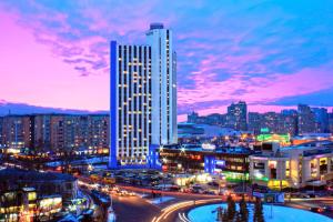 a city skyline at night with a tall building at Tourist Hotel Complex in Kyiv