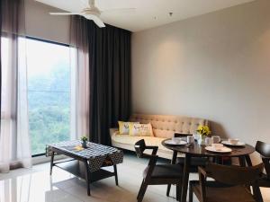 a living room with a couch and a table at Genting Geo 38 #New#Near Skyway # Premium Outlet in Genting Highlands