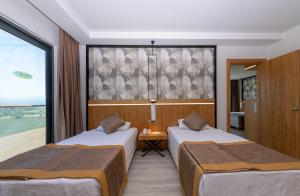 Postel nebo postele na pokoji v ubytování Akadia Luxury Sorgun - Adults Only 16 Plus