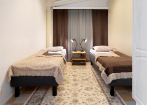 Ένα ή περισσότερα κρεβάτια σε δωμάτιο στο Hostel Eduskunta