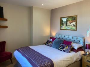 a bedroom with a bed and a picture on the wall at The Quies in Newquay