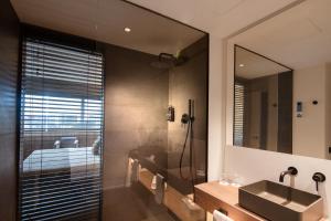 a bathroom with a sink and a mirror at BAH Barcelona Airport Hotel in El Prat de Llobregat