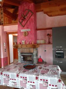 a room with a fireplace and a bed with a table at Torrent du Chateau casa vacanze in Aosta