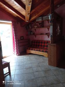 a living room with a bed and a window at Torrent du Chateau casa vacanze in Aosta