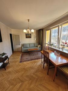 a living room with a table and a couch at MY SUITE 60th in Gdańsk