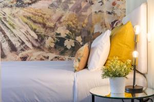 a bedroom with a bed with a painting on the wall at Lisbon Wine House - Rooms & Suites in Lisbon +62 photos