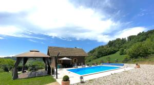 a villa with a swimming pool in a mountain at Holiday House Dorota in Mala Erpenja