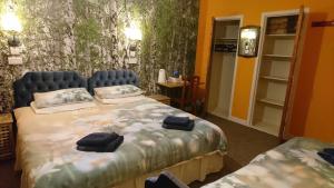 a bedroom with a bed with two bags on it at Scotland Shooting Club Kirriemuir in Kirriemuir