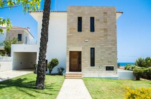 a house with a view of the ocean at Villa Hera in Ayios Theodhoros