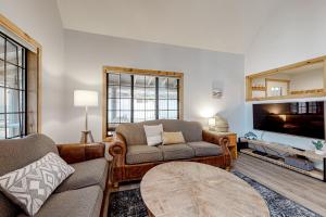 a living room with a couch and a tv at Circle 4 Ranch 25 | Discover Sunriver in Sunriver