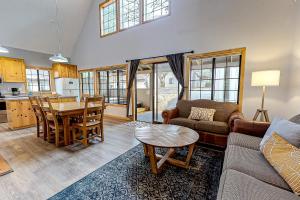 a living room with a couch and a table at Circle 4 Ranch 25 | Discover Sunriver in Sunriver