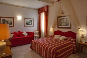 a bedroom with a red bed and a red couch at Miralago in Albano Laziale