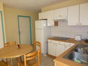 a small kitchen with a table and a sink at Chambre indépendante in Caen +12 photos