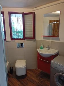 a bathroom with a sink and a toilet and a mirror at Ca Matley in Mestre