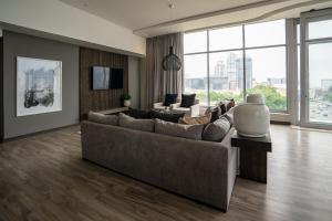 a large living room with a couch and a tv at The Capital Empire in Johannesburg