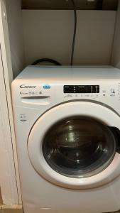 uma máquina de lavar e secar roupa num pequeno quarto em Marina'home em Ajaccio