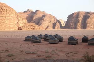 a group of nine tents in the desert at Wadi Rum Fire Camp in Wadi Rum