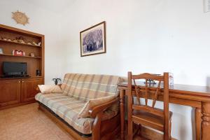a living room with a couch and a television at Casa El Cardon B1 in Buenavista del Norte