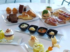a table with several plates of pastries and desserts at El Milano Real in Hoyos del Espino