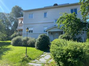 a gray house with a driveway in front of it at Sundsvall by M - Apartment in Sundsvall