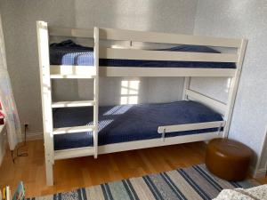 two bunk beds in a room with blue sheets at Pärla med egen brygga in Västerås