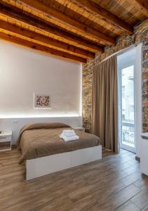una camera con letto e muro di mattoni di La casa di Mattia a La Spezia