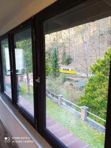 a window with a view of a train at Elbenland Apartments & Bungalows in Bad Schandau