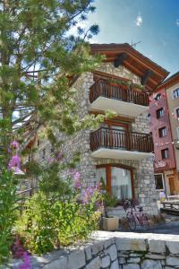 a building with balconies and flowers in front of it at L'Annexe in Val-d'Isère