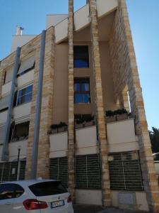 a building with some plants on the side of it at Gateway AIRPORT Bari ELEGANT FLAT with car park in Bari