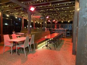 a restaurant with wooden tables and chairs and lights at The Diamond Inn in Ponteland