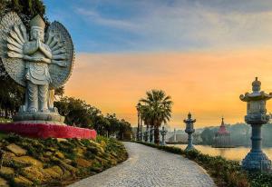 a statue of an angel on a path next to a river at WATERS HOUSE - Feel at Home ir our Sea in Peniche