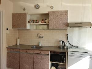 a kitchen with a sink and a refrigerator at Hout 25 in Westkapelle