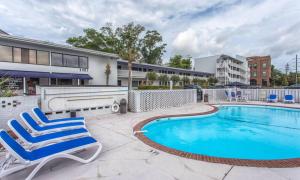 a swimming pool with lounge chairs next to a building at The Waterway Pet Friendly by Carolina Retreats in Wrightsville Beach