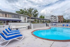 a pair of chairs and a swimming pool at The Waterway Pet Friendly by Carolina Retreats in Wrightsville Beach