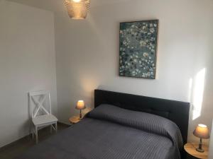 a bedroom with a bed and a painting on the wall at U SOLE in Ajaccio