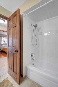 a bathroom with a bath tub and a shower at Bayside Beach House in Burlington