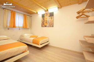 A bed or beds in a room at Appartamenti Green by Livigno Accomodation
