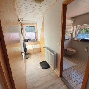 a small bathroom with a toilet and a window at B&B Waldcafe in Altenau