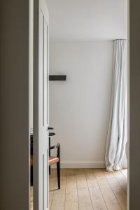 an open door to a room with a desk and a chair at Hotel Nenuphar in Ghent