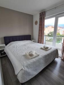 a bedroom with a bed with two towels on it at Explore the Croatian Coast and Relax in Modern Comfort in Kaštela
