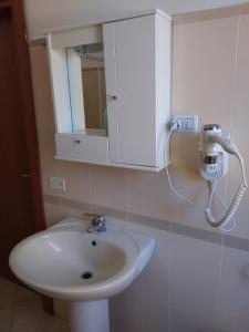 a bathroom with a white sink and a cabinet at G&G - Bed & Breakfast in Vieste +37 photos
