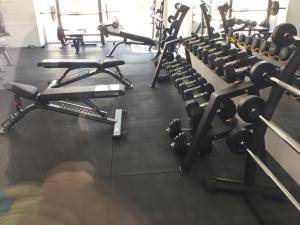 a gym filled with lots of dumbbell machines at Apartment Helena in Paralimni
