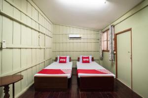 Cama o camas de una habitación en OYO 691 Don Muang Boutique House