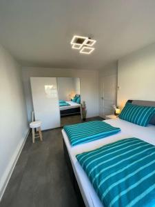 a bedroom with two beds with blue and white sheets at komfortable Ferienwohnung in Halle-Kröllwitz in Halle an der Saale
