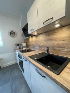 a kitchen with a sink and a wooden counter top at komfortable Ferienwohnung in Halle-Kröllwitz in Kröllwitz