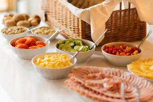 a table topped with bowls of different types of food at Penzion Panský dvůr Telč in Telč