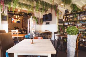 a restaurant with tables and chairs and plants at Casa Laura Sorrento in Sorrento