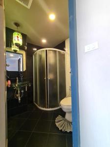 a bathroom with a shower and a toilet at Sridonchai Heritage, Night Bazaar Chiang Mai in Chiang Mai