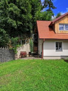 a house with a patio and a table in the yard at Ferienhaus am Himberg in Straden