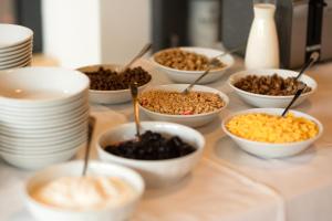 a table topped with bowls of different types of food at Penzion Panský dvůr Telč in Telč